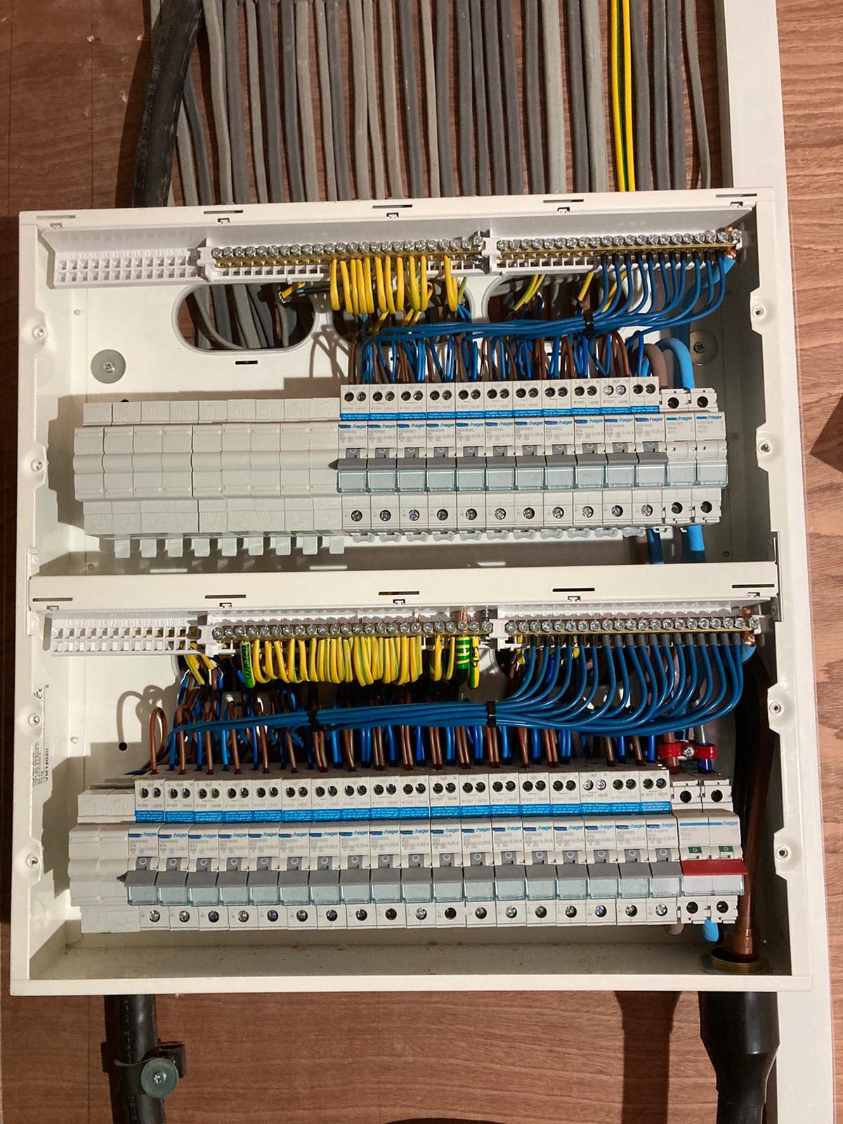 A double-row consumer unit with the cover off, neatly wired